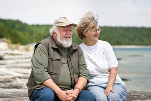 senior couple sitting at beach